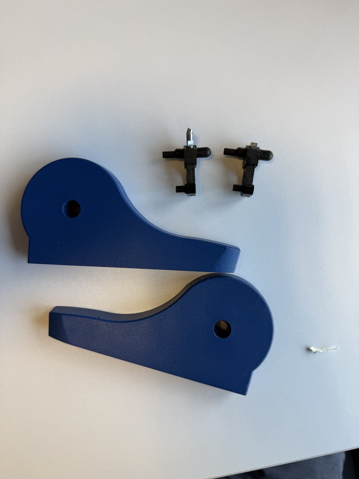 Original blue laboratory equipment housings and small black mechanical components supplied as samples